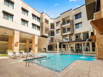 a swimming pool in front of an apartment building at Scottsdale Grand, Scottsdale, AZ